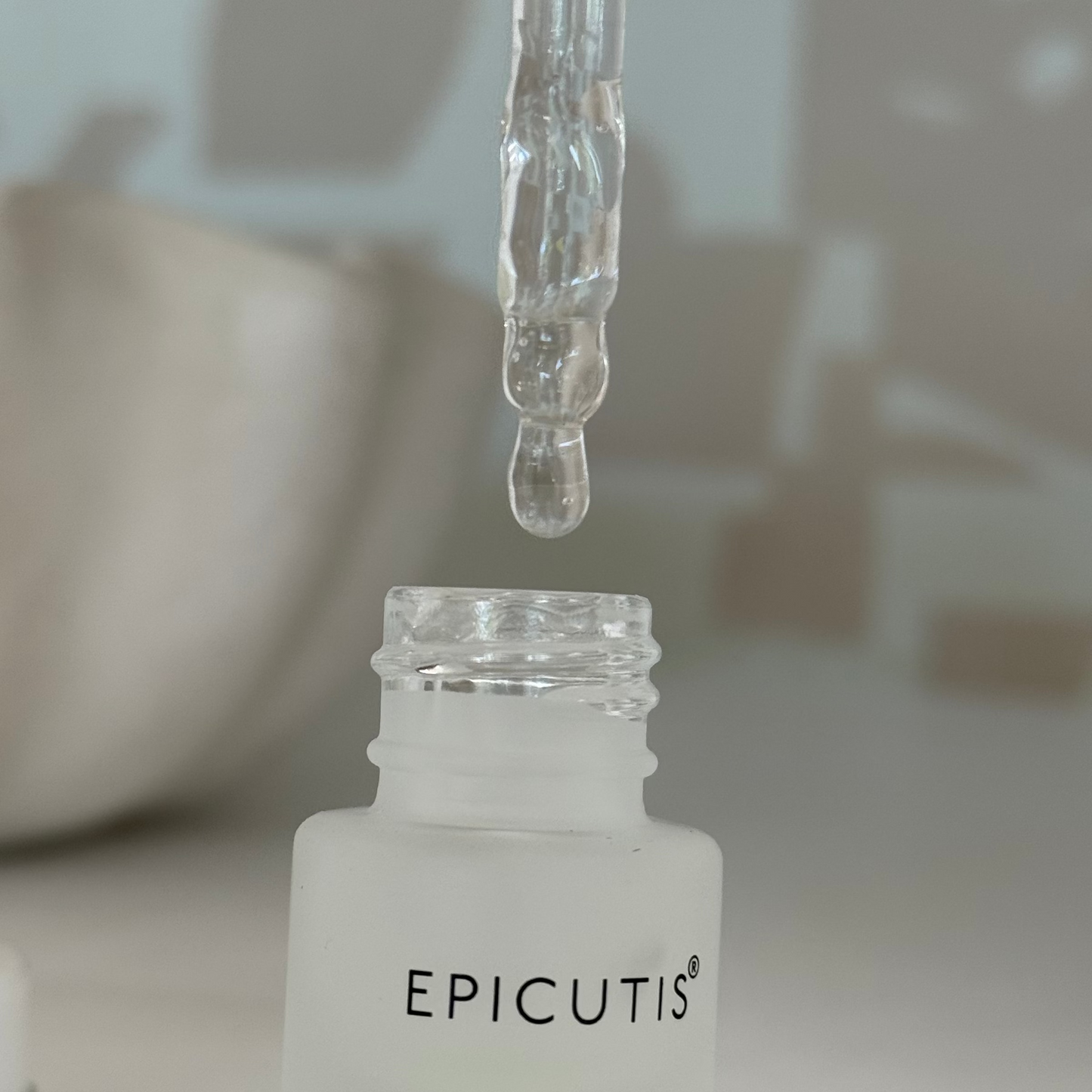 Close up image of epicutis lipid serum showing the serum dropper and the lipid serum dropping out
