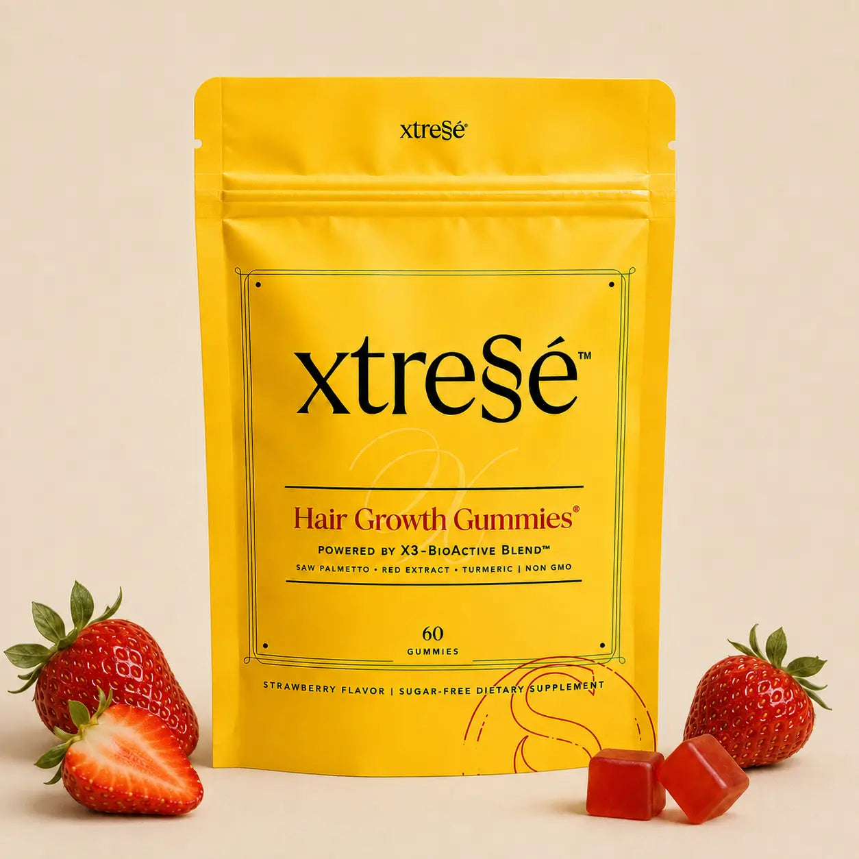 XtreSé Hair Growth Gummies with two red gummy candies resting near the bottom right of the package. For sale at Clover Skin Bar.